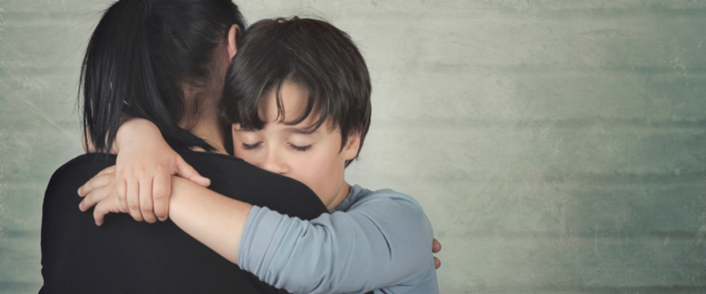 A comforting embrace shows support and understanding for a child's wellbeing.