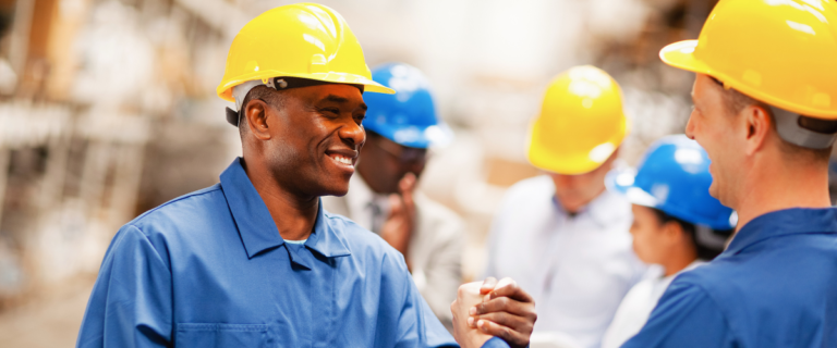 Workers in hard hats collaborate effectively in a construction setting.