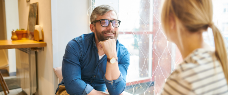 Two people having a supportive conversation in a cozy office setting.