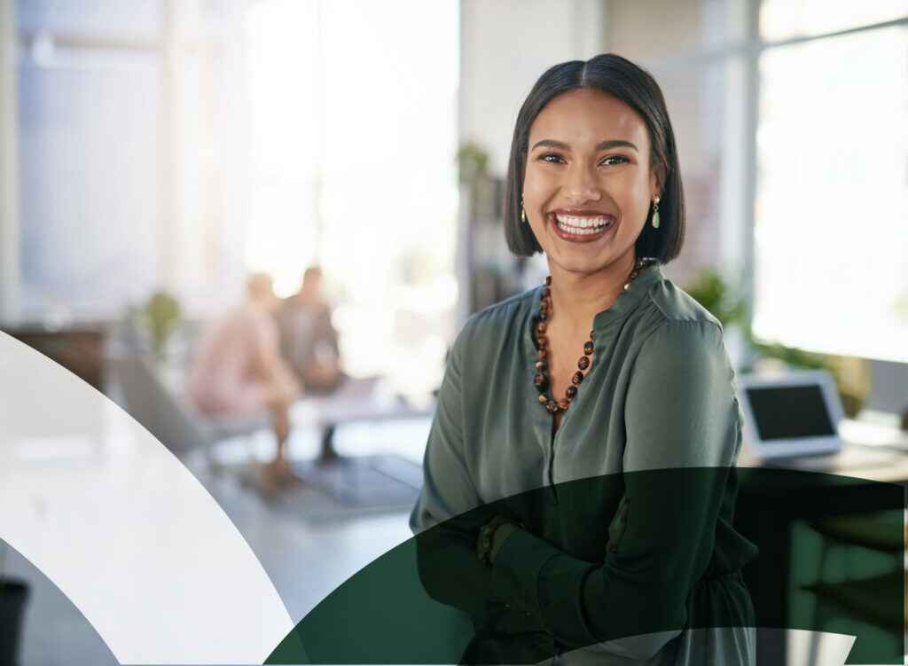 Smiling woman in stylish office setting with modern leather furniture.